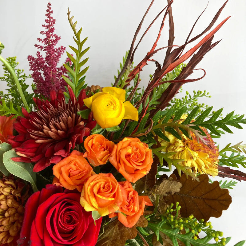 Colorful bouquet of flowers including roses and astilbe on a white background