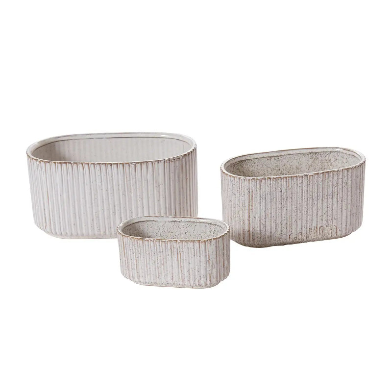 Three oval ceramic planters with ribbed texture on a white background