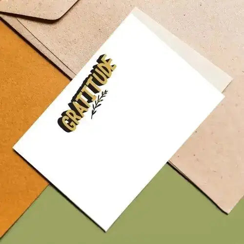 White card with 'Gratitude' text on a textured surface