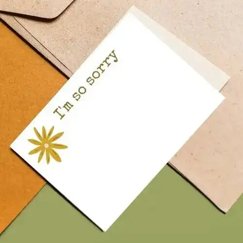 Card with 'I'm so sorry' text and a yellow flower on a multicolored background