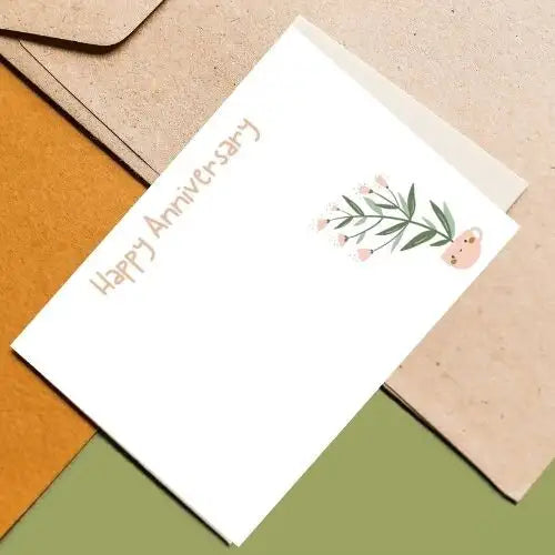 Greeting card with 'Happy Anniversary' text and floral design on a textured surface.