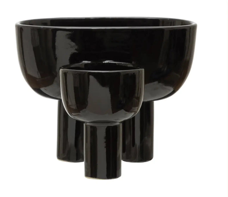 Set of three black ceramic bowls on a white background