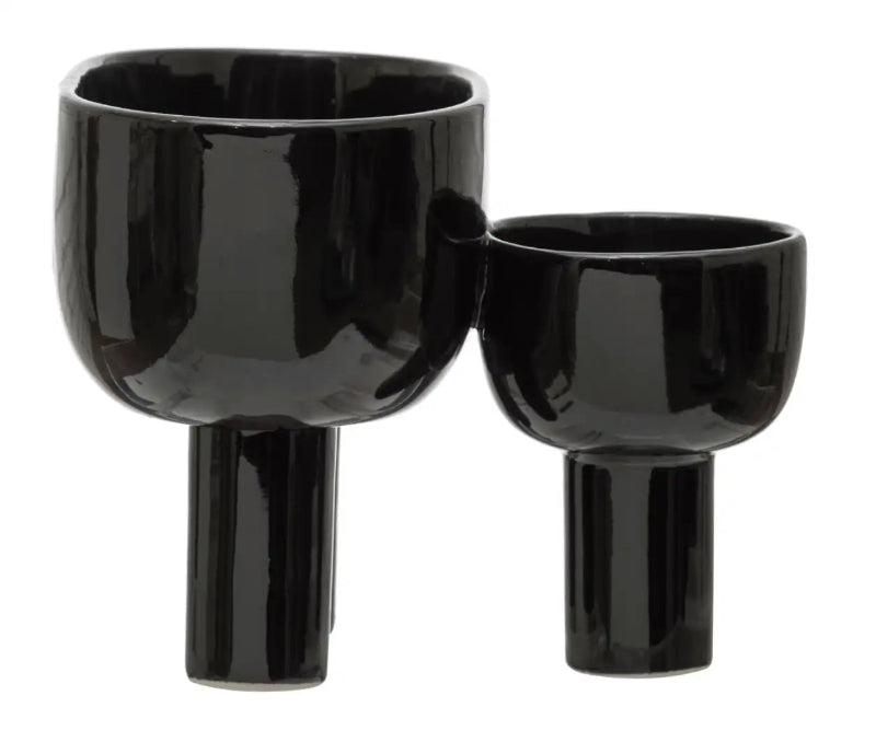 Two black ceramic vases on a white background