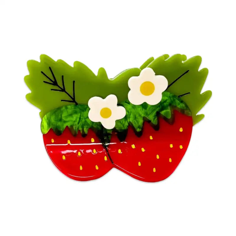 Strawberry-themed hair claw with green leaves and white flowers on a white background