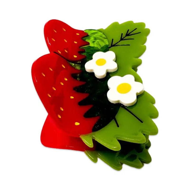 Strawberry-shaped hair clip with green leaves and white flowers on a white background