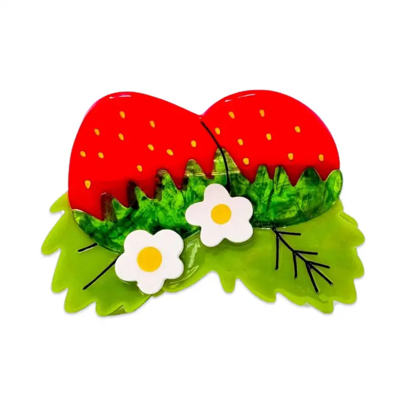 Strawberry-themed hair clip with green leaves and white flowers on a white background