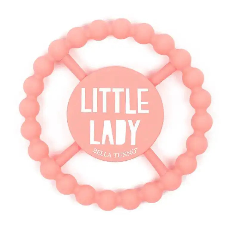 Pink teething ring with 'Little Lady' and 'Hella Tunno' text on a white background