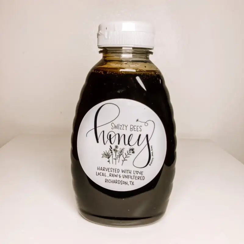 Bottle of Swizzy Bees honey with a white label on a light background