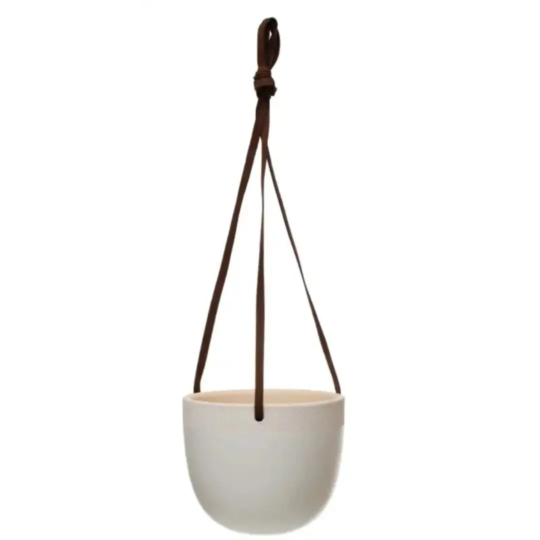 White hanging planter with a brown strap on a white background