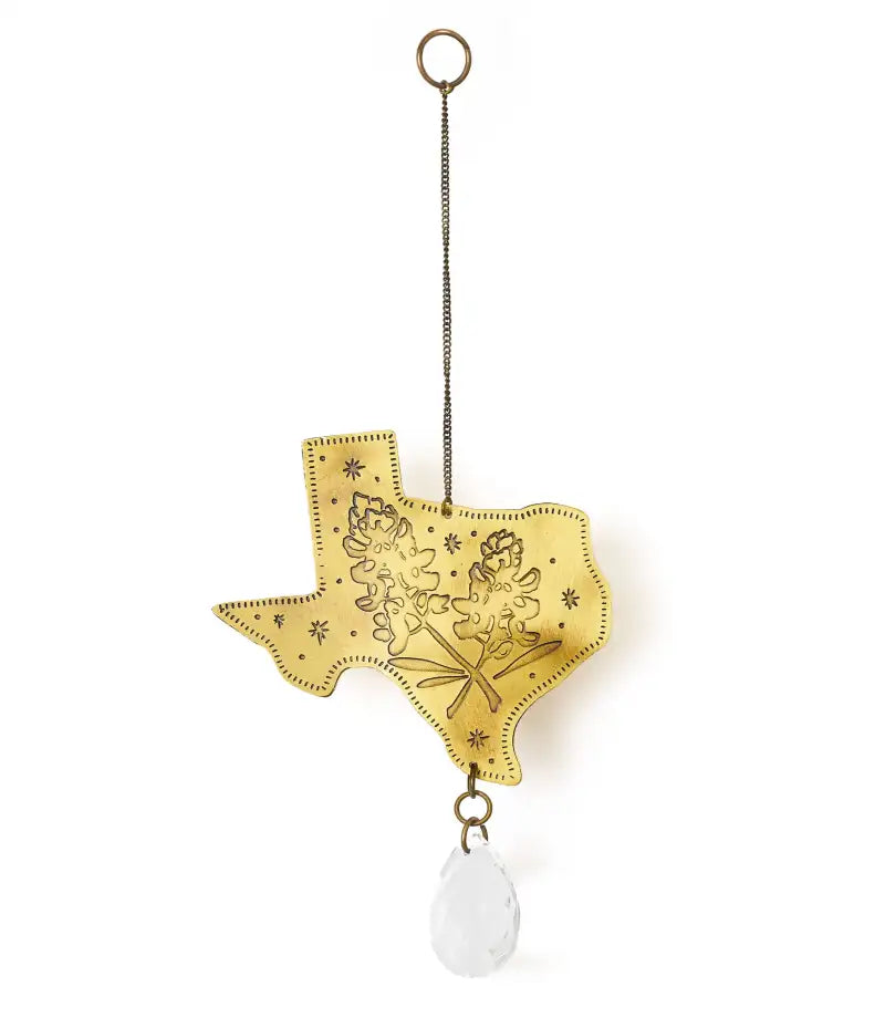 Decorative hanging ornament shaped like the state of Texas with a white stone at the bottom on a white background.