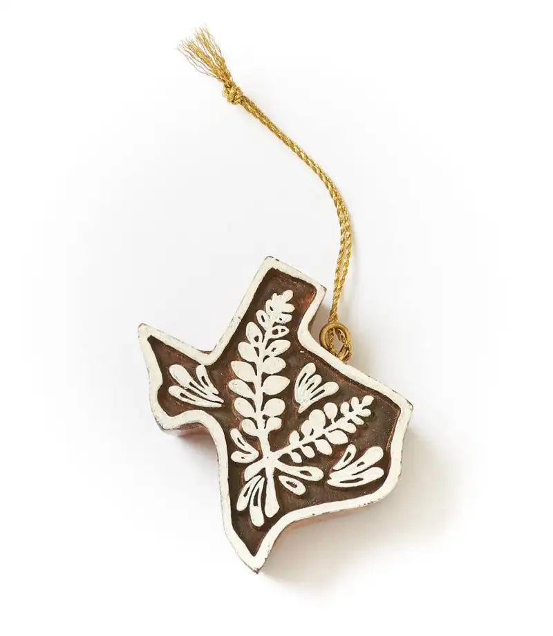 Decorative ornament shaped like a bird with a floral pattern on a white background