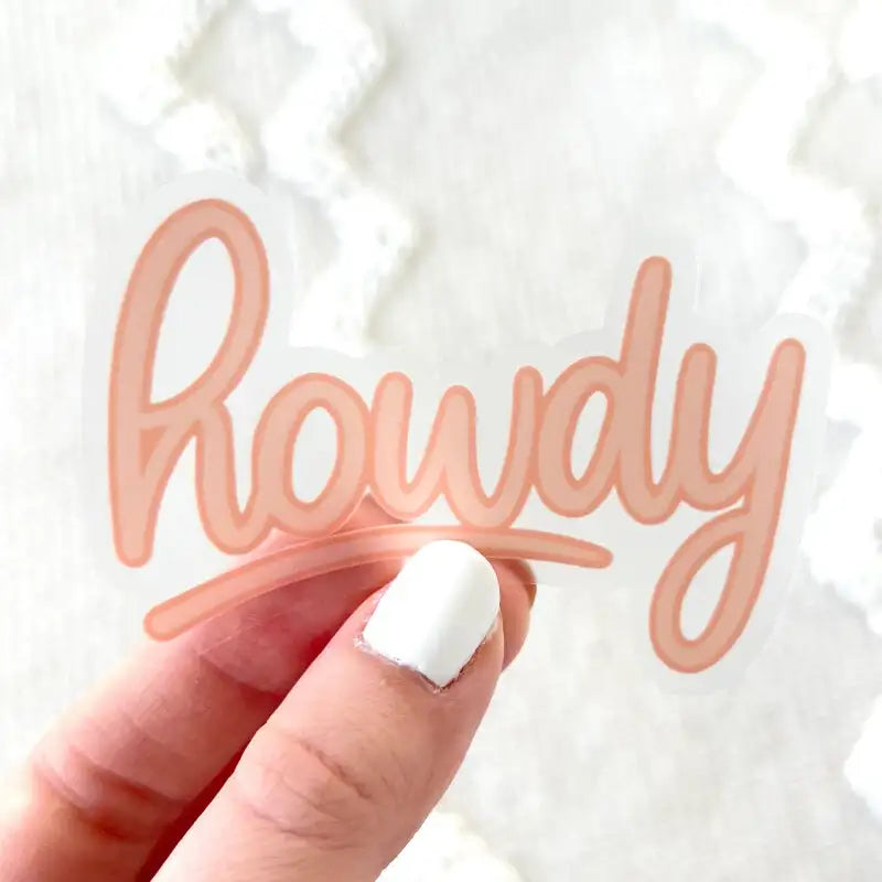 Hand holding a clear acrylic block with 'Howdy' text against a white textured background