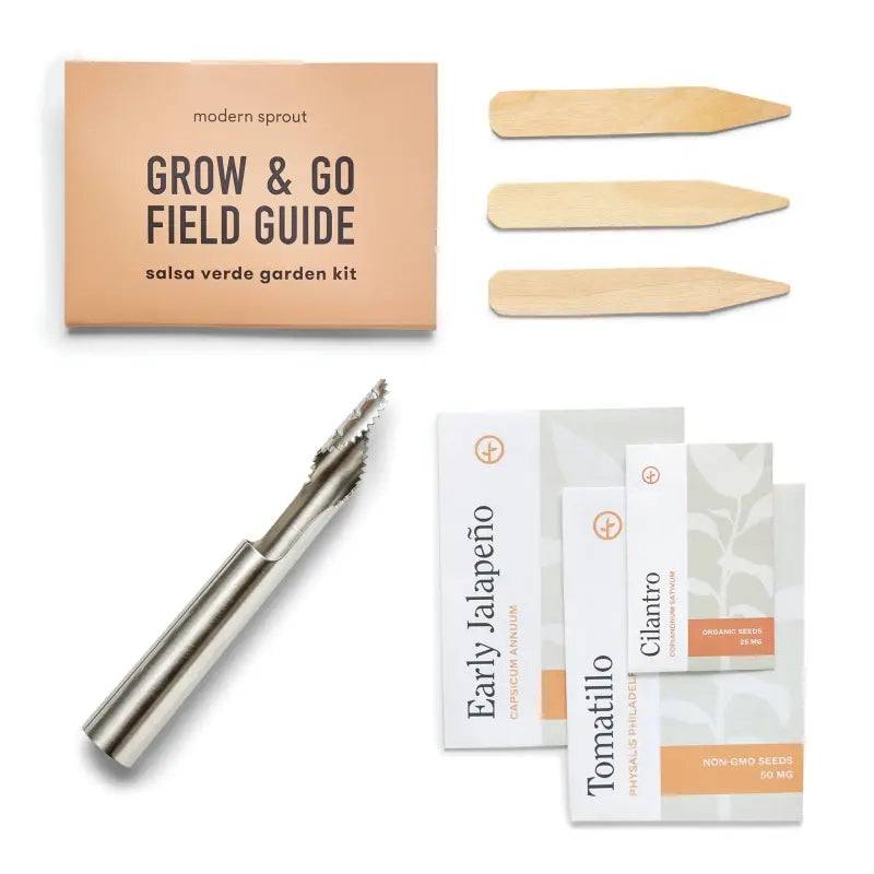 Garden kit with 'modern sprout' grow & go field guide, seed packets, and a tool on a white background.