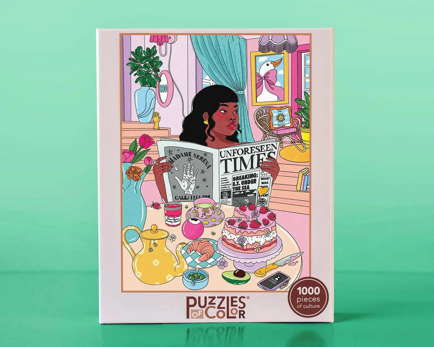 Puzzles of Color packaging with illustration of a woman reading a newspaper in a room with plants and a cake.