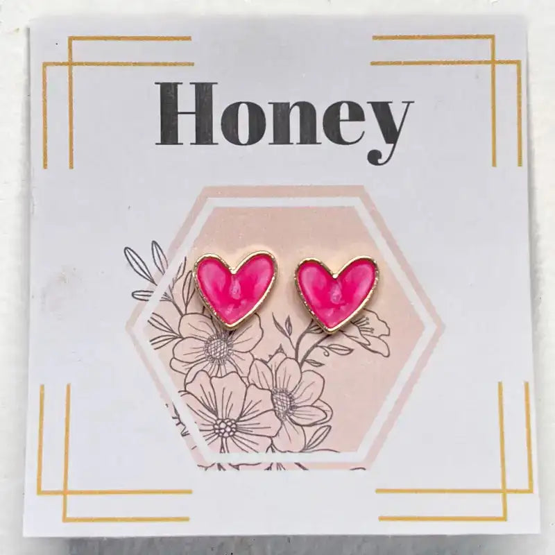 Pink heart-shaped earrings on a card with floral design and 'Honey' text.