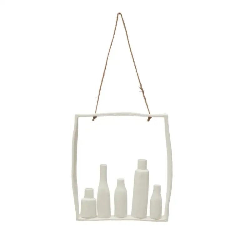 Hanging ceramic shelf with five white ceramic bottles on a white background