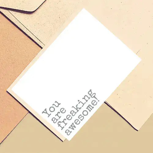 Note with 'You are freaking awesome!' text on a textured surface