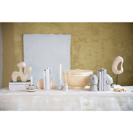 Decorative items on a shelf against a textured wall