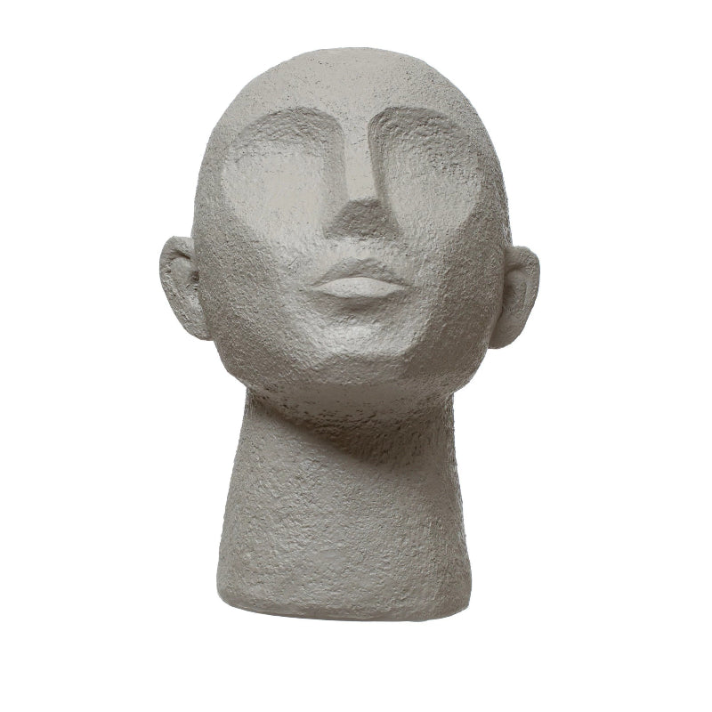 Stone-like sculpture of a human head on a white background